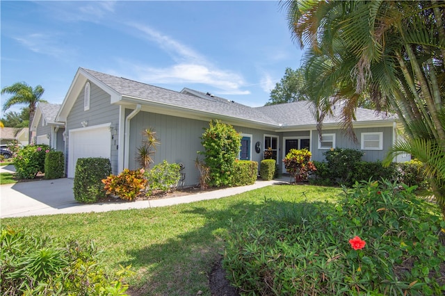 single story home featuring a front lawn and a garage