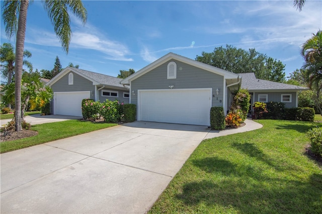 ranch-style home featuring a garage and a front yard