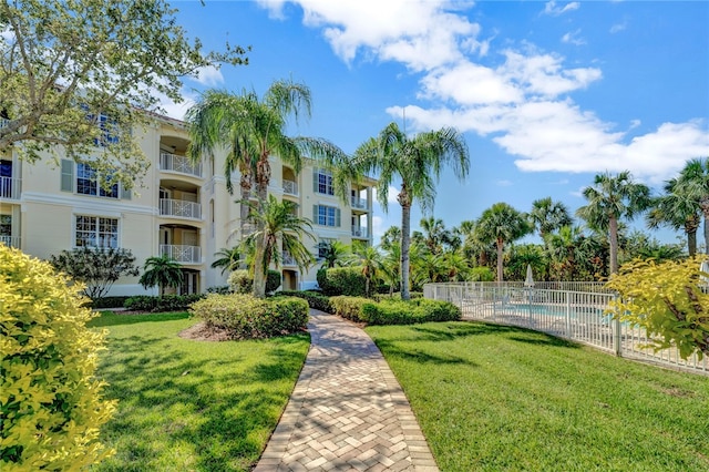 view of community featuring a lawn and a pool