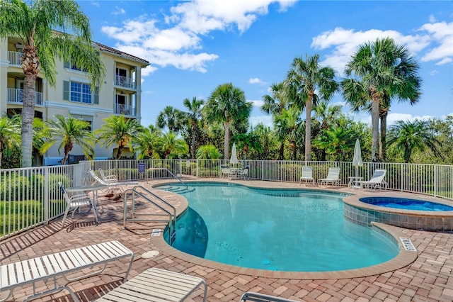 view of pool featuring a hot tub and a patio area