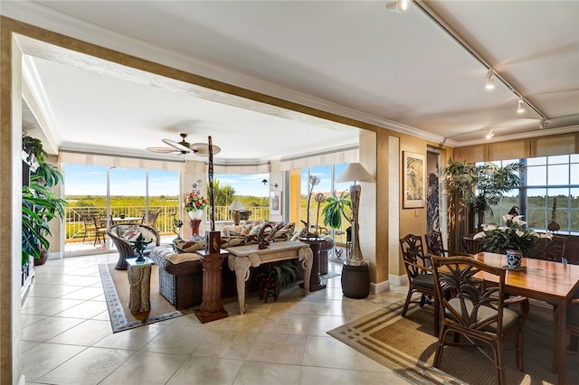 dining space featuring a wealth of natural light, ceiling fan, crown molding, and light tile patterned flooring