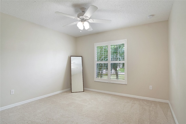 carpeted empty room with a textured ceiling and ceiling fan