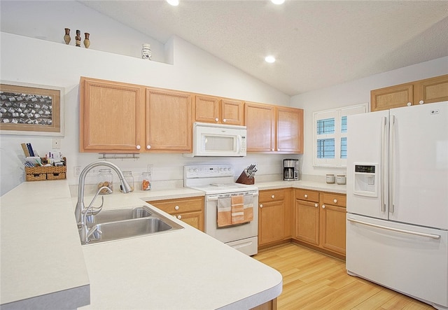 kitchen with a textured ceiling, white appliances, vaulted ceiling, sink, and light hardwood / wood-style flooring