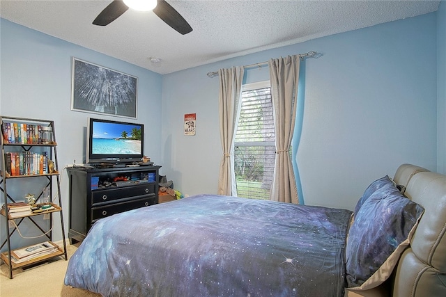 carpeted bedroom with a textured ceiling and ceiling fan