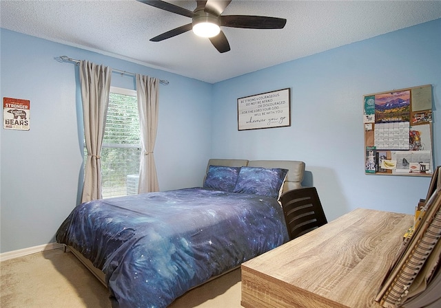 bedroom with carpet, ceiling fan, and a textured ceiling