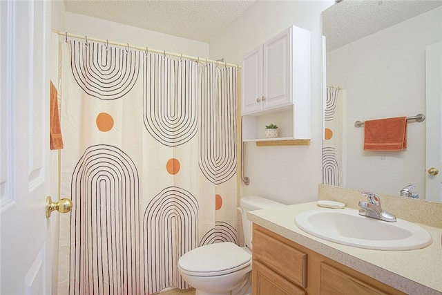 bathroom featuring vanity, toilet, and a textured ceiling