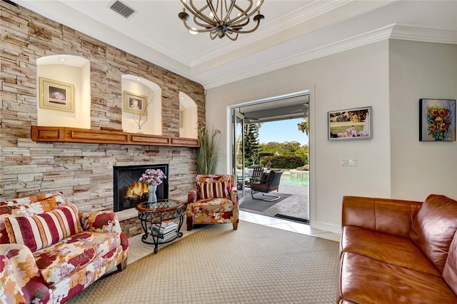 living room featuring crown molding, light colored carpet, a stone fireplace, and a chandelier