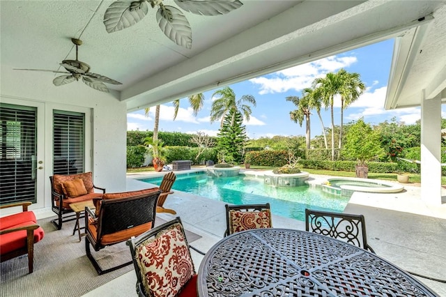 view of pool with ceiling fan, an in ground hot tub, and a patio