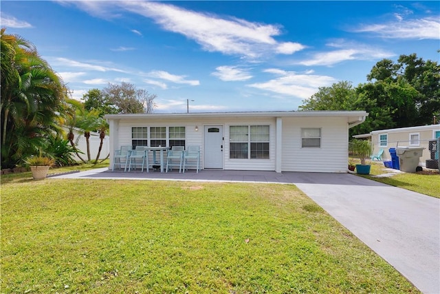 1311 3rd Ct, Vero Beach, FL 32960 - back of house featuring a yard, a patio area, and driveway
