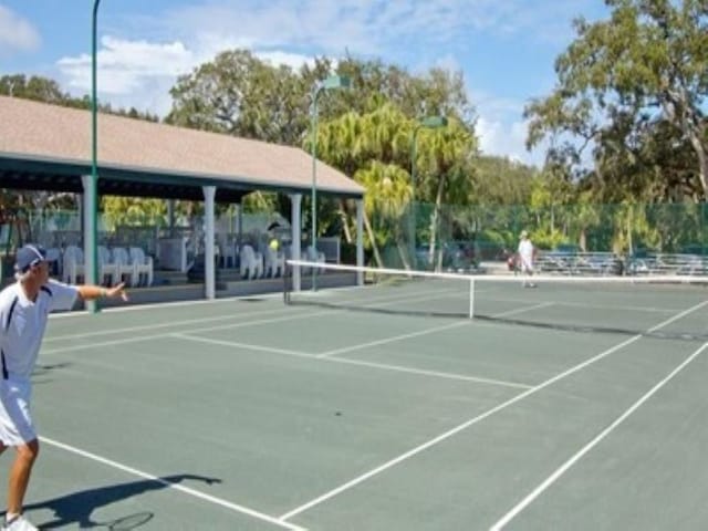 view of tennis court featuring fence