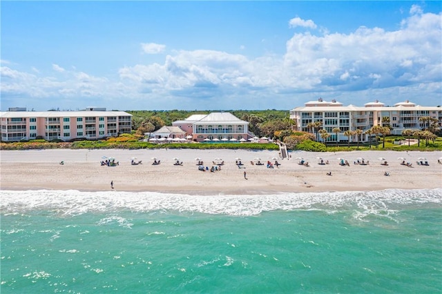 birds eye view of property featuring a view of the beach and a water view