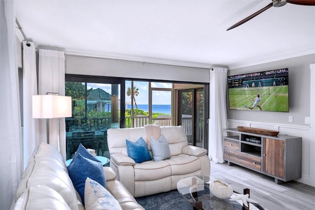 living area with ceiling fan and light wood-style flooring