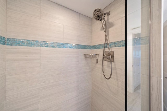 full bath featuring a tile shower