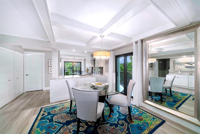 dining space with beamed ceiling, coffered ceiling, light wood-style flooring, and a healthy amount of sunlight