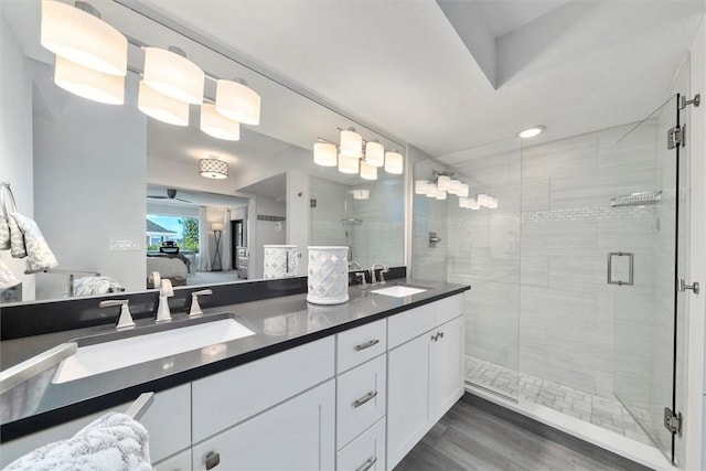 full bathroom featuring a sink, a stall shower, and ensuite bath