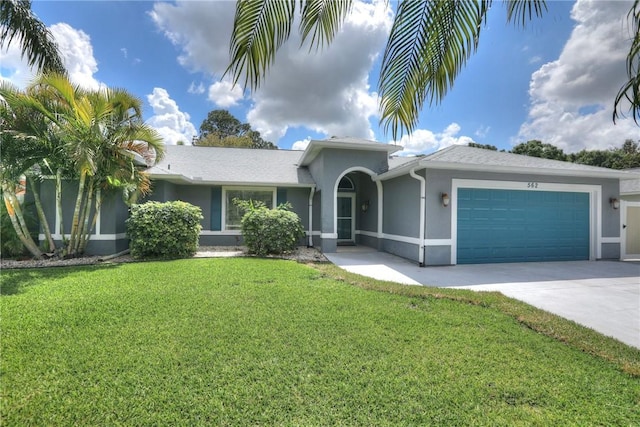 single story home featuring a front yard, driveway, stucco siding, and an attached garage