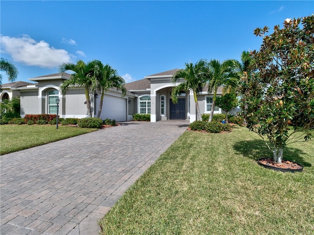 view of front of home with a garage and a front lawn