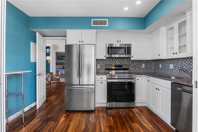3554 Ocean Dr Unit 403S, Vero Beach, FL 32963 - kitchen with stainless steel appliances, dark wood-type flooring, white cabinetry, and recessed lighting