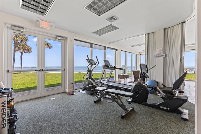 3554 Ocean Dr Unit 403S, Vero Beach, FL 32963 - gym featuring a water view, carpet floors, and french doors