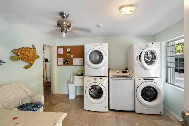 laundry area with stacked washing maching and dryer, light tile patterned floors, ceiling fan, and washing machine and clothes dryer