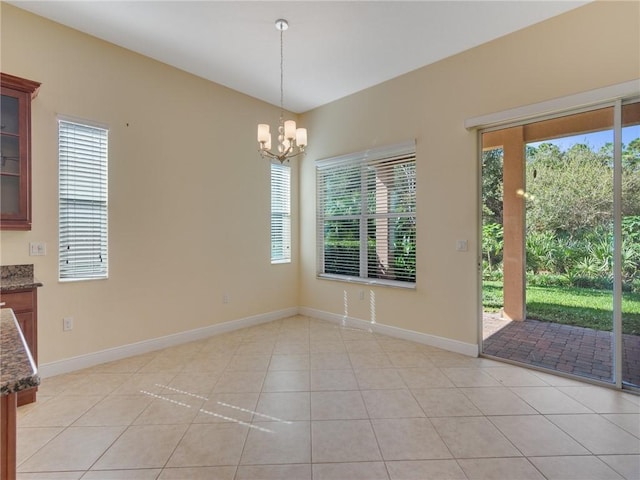 unfurnished dining area featuring a chandelier and light tile patterned floors