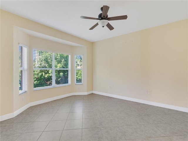 empty room featuring light tile patterned floors and ceiling fan