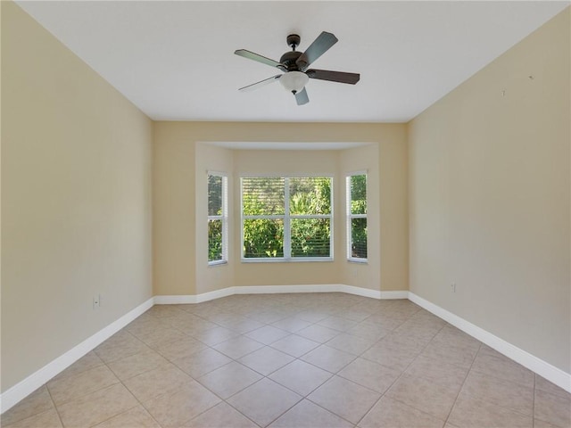 empty room featuring light tile patterned floors and ceiling fan