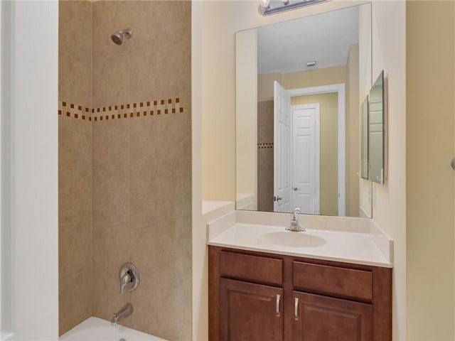 bathroom featuring vanity and tiled shower / bath combo