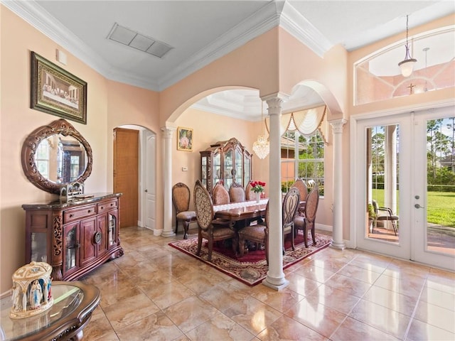 entryway featuring decorative columns, baseboards, visible vents, arched walkways, and crown molding