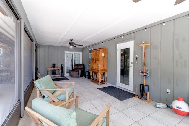 sunroom / solarium featuring ceiling fan