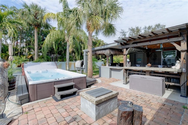 view of patio with a hot tub and ceiling fan