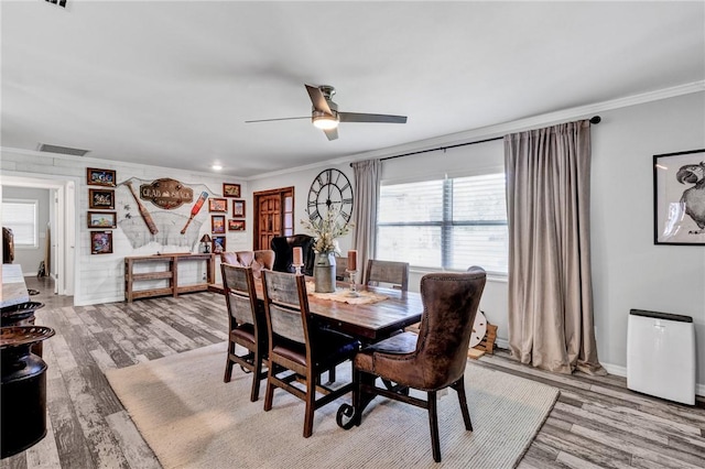 dining area with ceiling fan, light hardwood / wood-style flooring, and ornamental molding