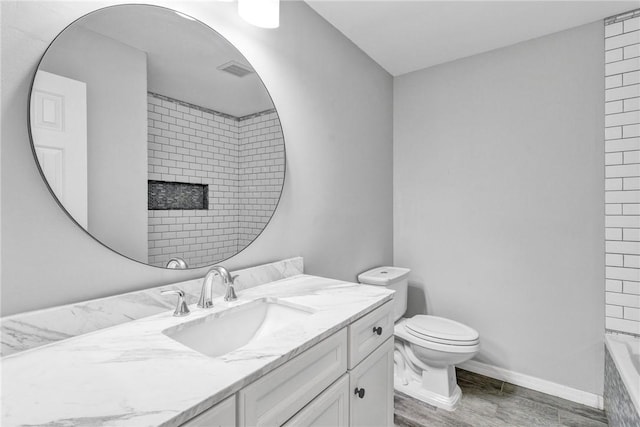 full bathroom with plus walk in shower, hardwood / wood-style floors, vanity, and toilet