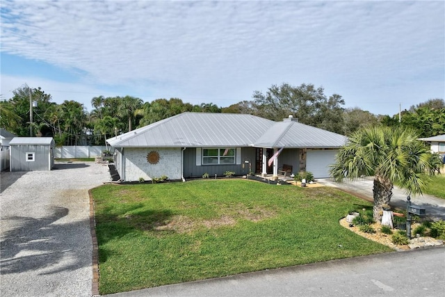 single story home featuring a shed, a front yard, and a garage