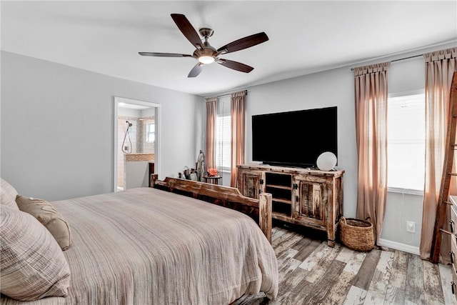 bedroom featuring ensuite bath, ceiling fan, and light hardwood / wood-style floors