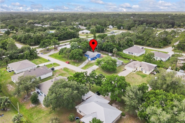 9335 103rd Ave, Vero Beach, FL 32967 - aerial view of property and surrounding area with nearby suburban area and a heavily wooded area