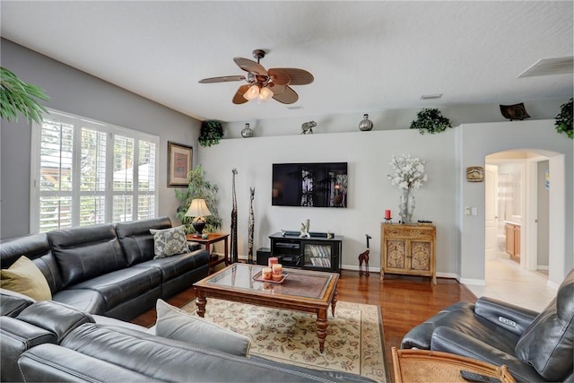 living room with hardwood / wood-style flooring and ceiling fan