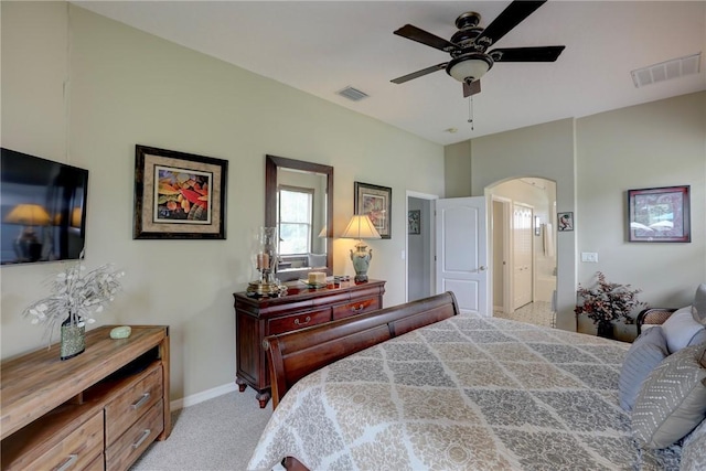 bedroom featuring ensuite bath, ceiling fan, and light colored carpet