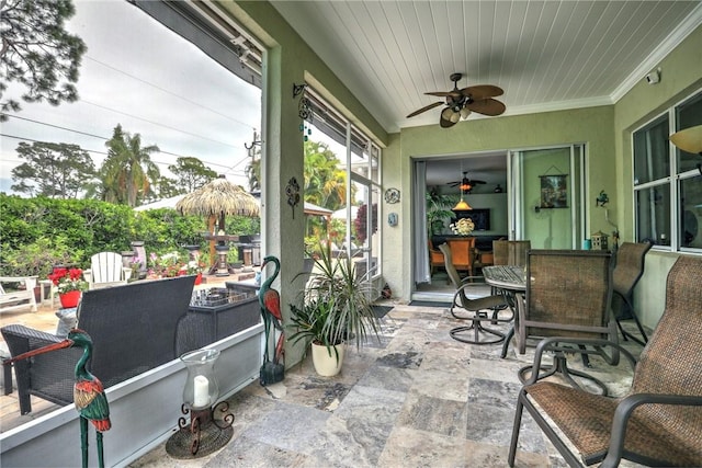 sunroom / solarium with ceiling fan and wooden ceiling