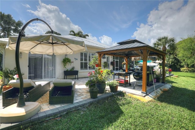 rear view of property featuring a gazebo, a patio, and a lawn