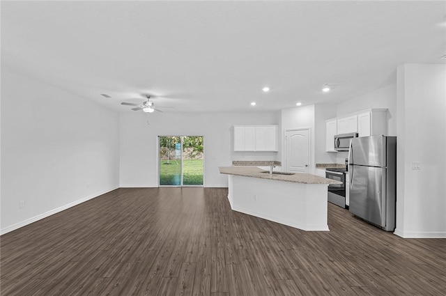 8255 97th Ave, Vero Beach, FL 32967 - kitchen with stainless steel appliances, dark wood-style flooring, white cabinetry, a ceiling fan, and open floor plan