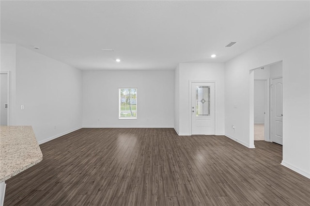 8255 97th Ave, Vero Beach, FL 32967 - unfurnished living room with dark wood-type flooring and recessed lighting