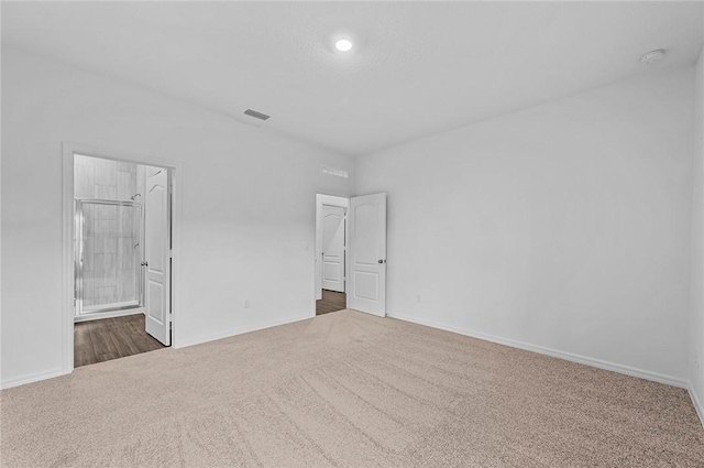 8255 97th Ave, Vero Beach, FL 32967 - unfurnished bedroom with carpet floors, recessed lighting, and ensuite bath