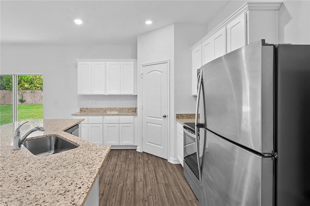 8255 97th Ave, Vero Beach, FL 32967 - kitchen featuring appliances with stainless steel finishes, white cabinets, recessed lighting, dark wood-style flooring, and light stone counters