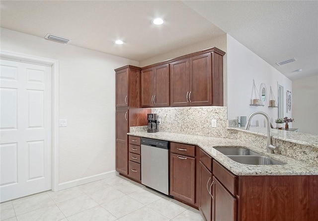 kitchen featuring visible vents, a sink, light stone countertops, and stainless steel dishwasher