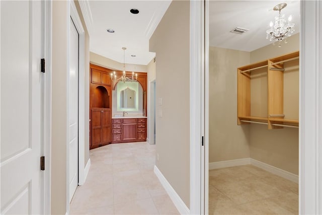 104 Island Plantation Ter Unit 304, Vero Beach, FL 32963 - corridor featuring light tile patterned flooring, a chandelier, baseboards, and visible vents