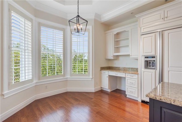 104 Island Plantation Ter Unit 304, Vero Beach, FL 32963 - interior space featuring open shelves, a wealth of natural light, paneled fridge, and light wood-style flooring