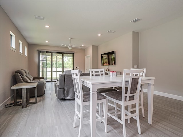 dining space with light wood-type flooring and ceiling fan