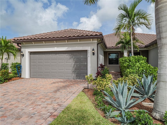 mediterranean / spanish house with a garage