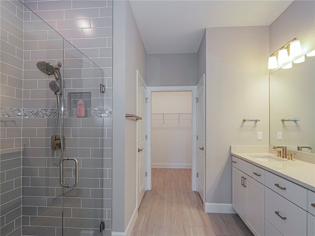 bathroom featuring vanity, an enclosed shower, and hardwood / wood-style flooring